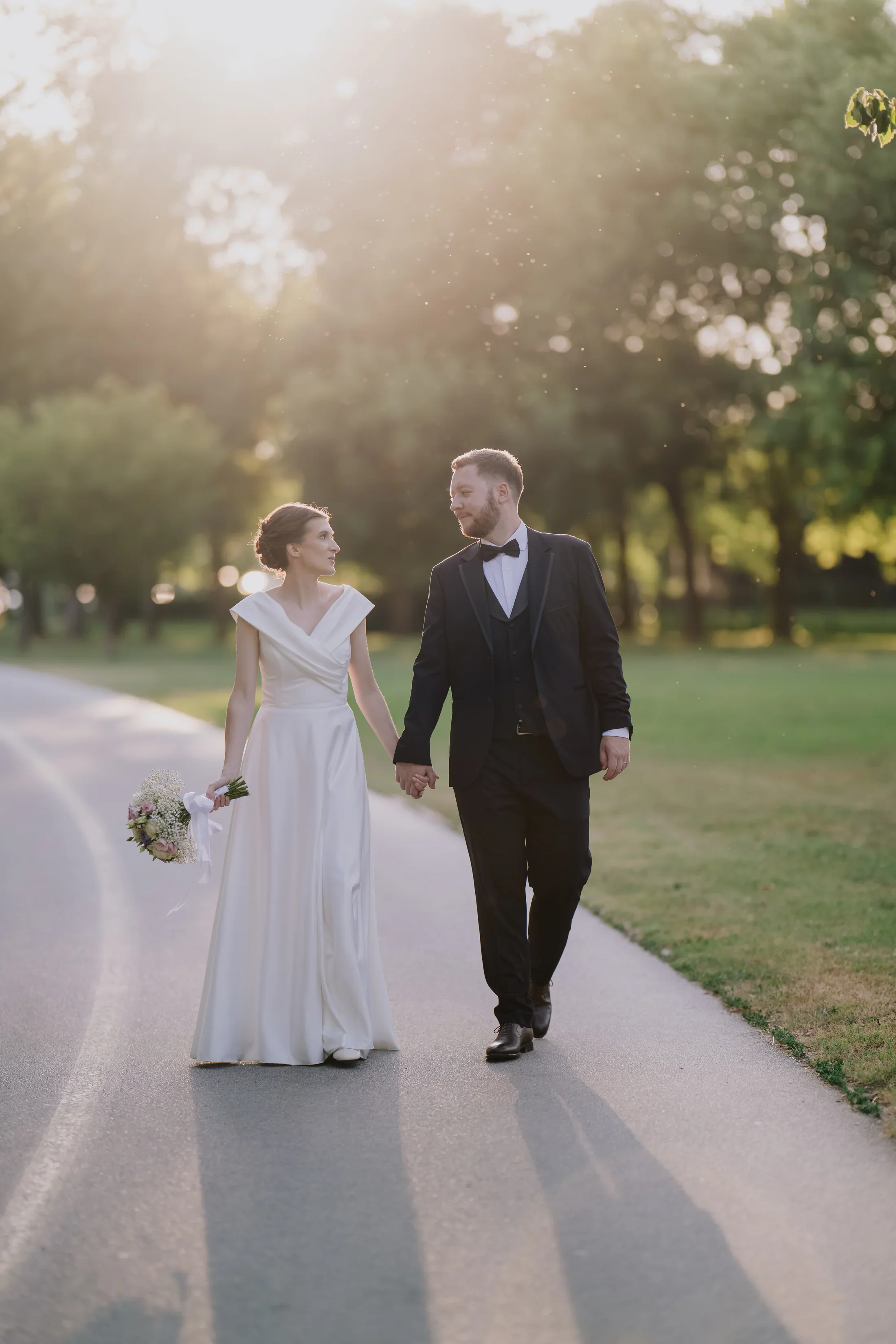 Bride and groom walking by Jarun Lake