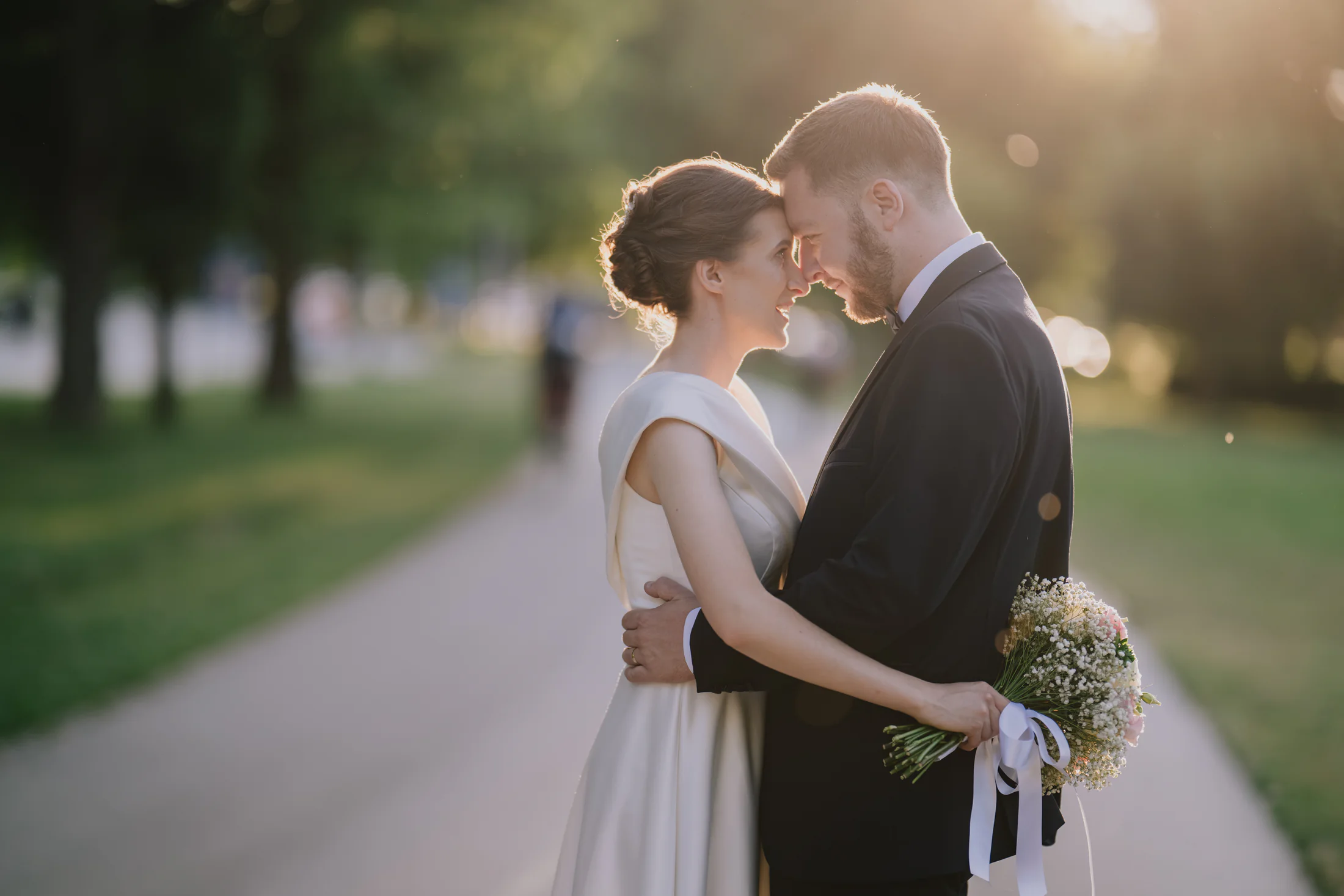 Bride and groom embracing at golden hour