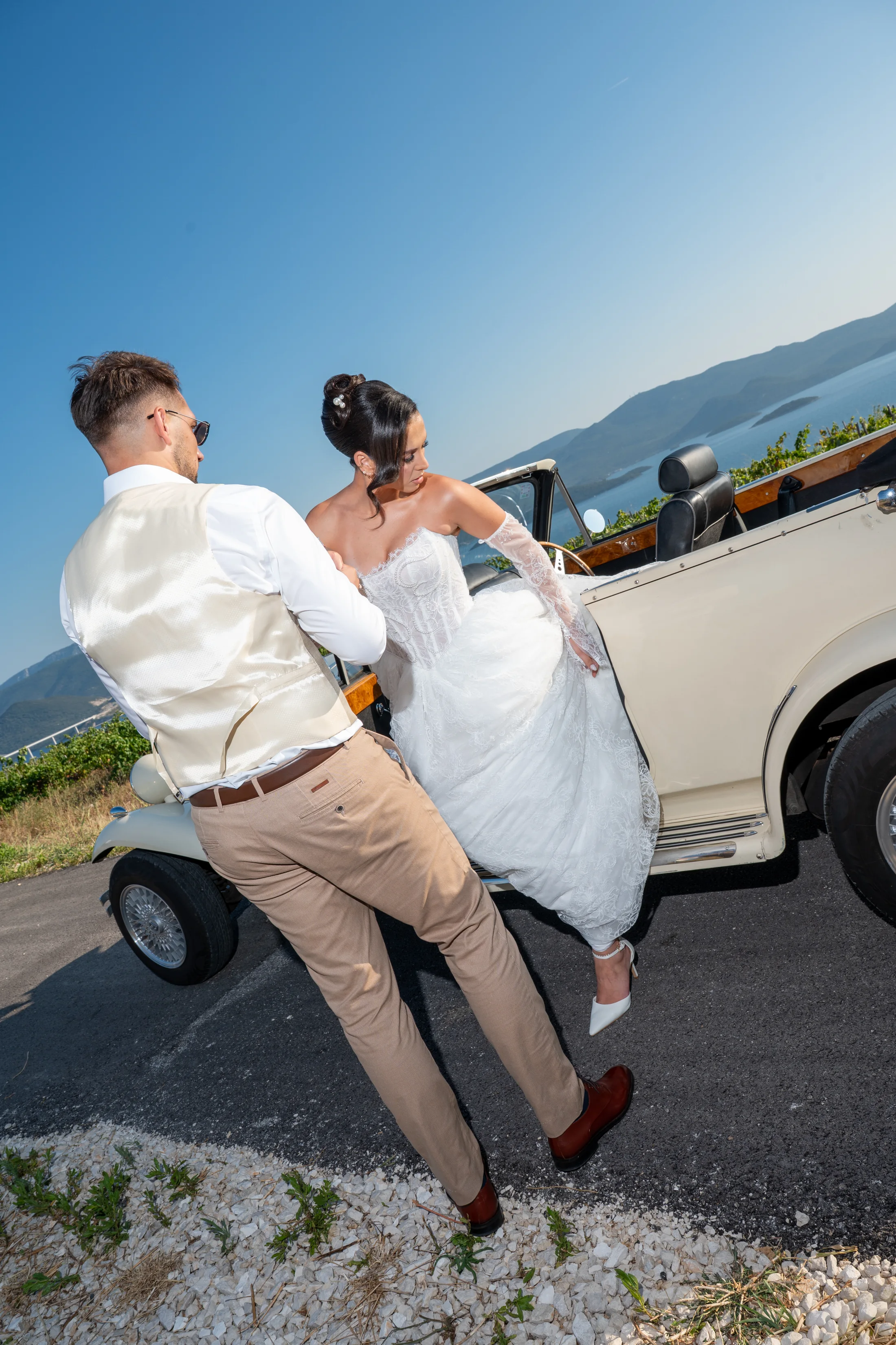 Editorial bridal fashion beside a vintage convertible