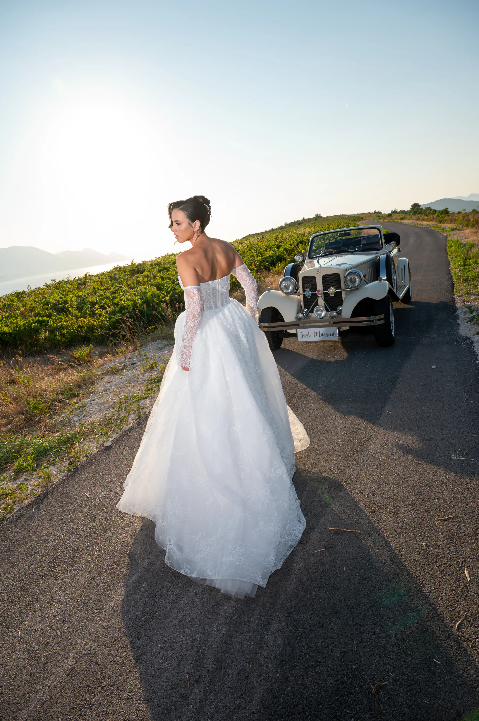 Editorial bridal portrait beside a vintage convertible