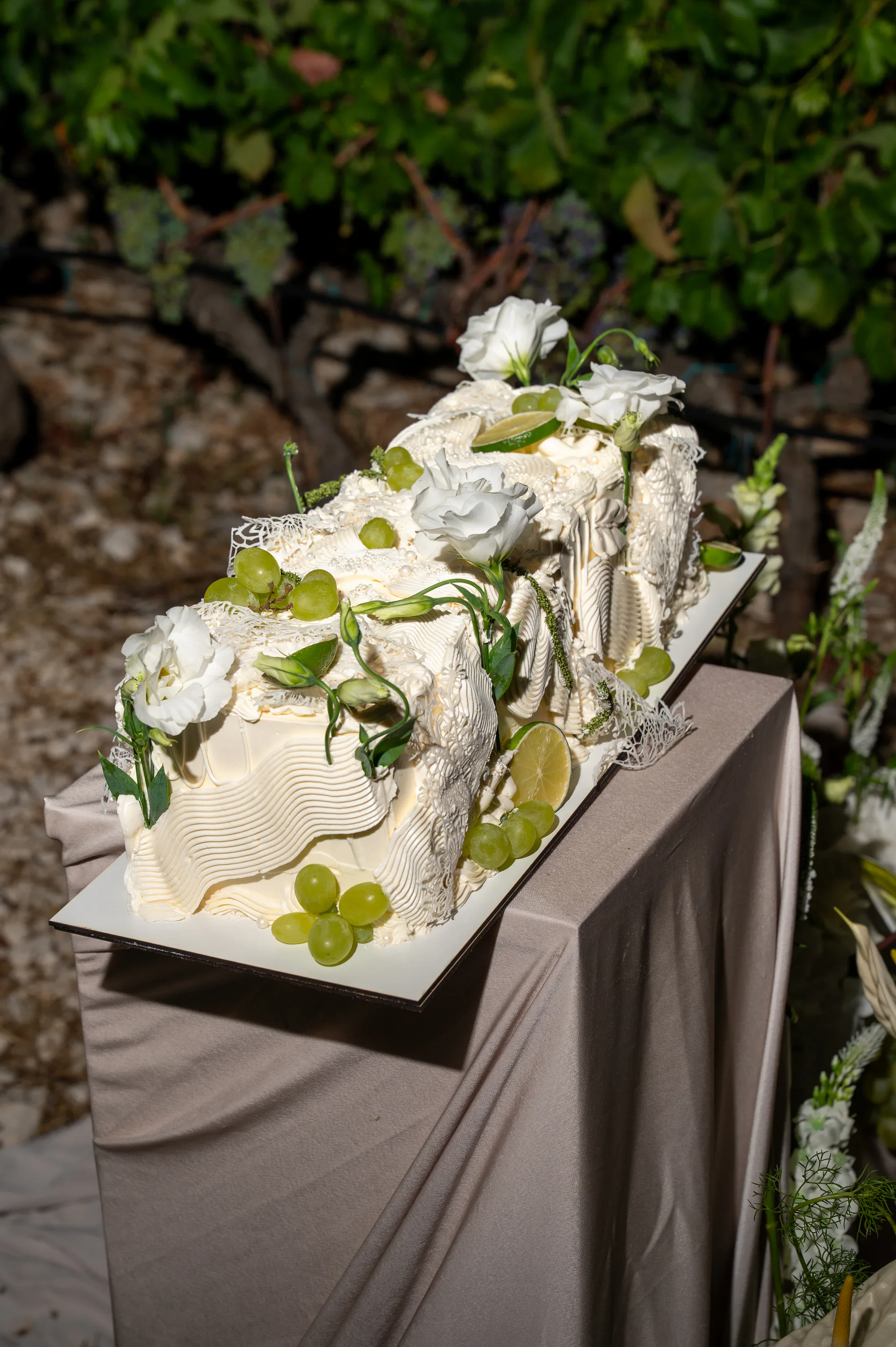 Editorial wedding cake with white flowers and fruit