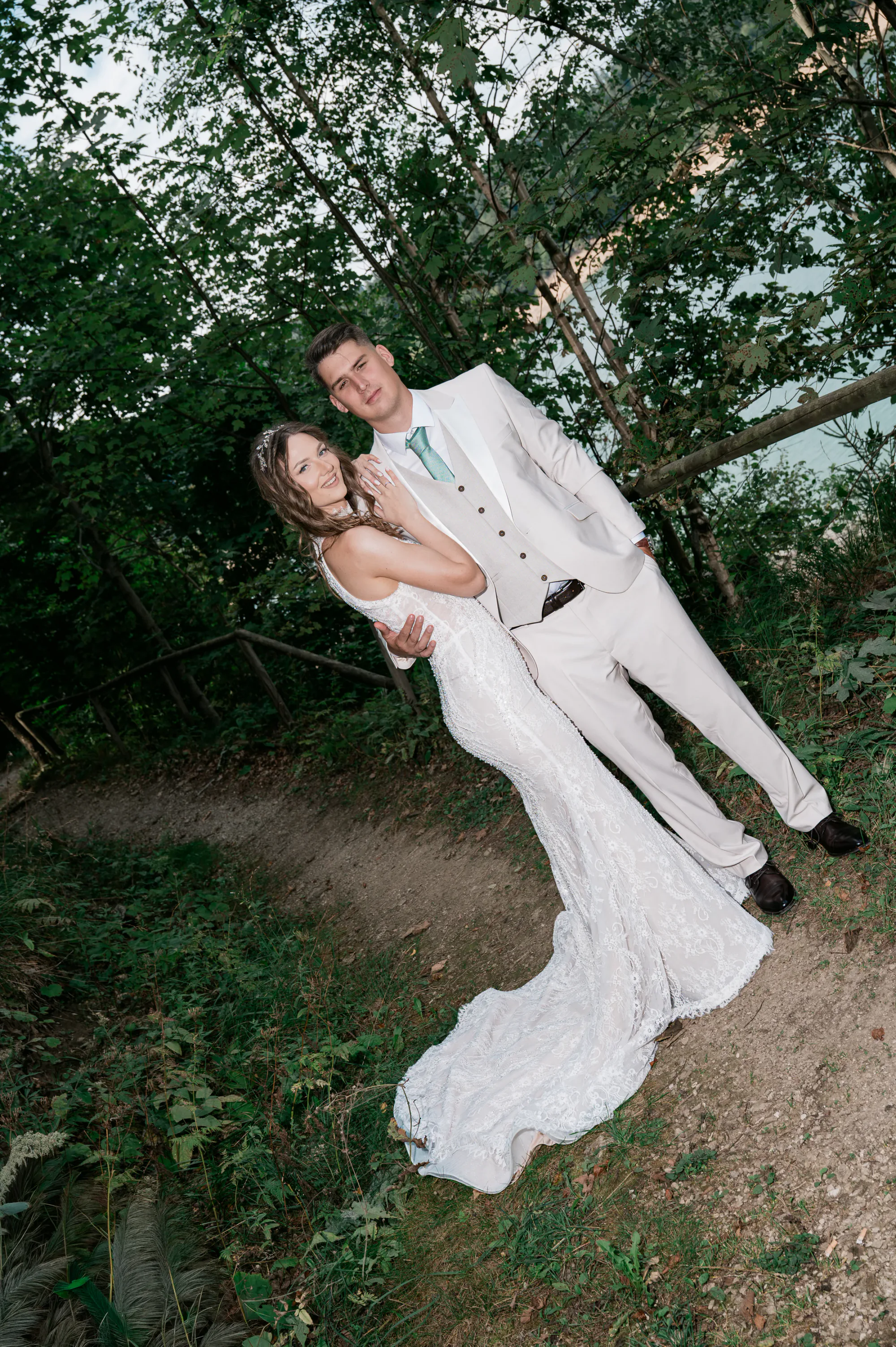 Bride and groom portrait in a forest beside a lake