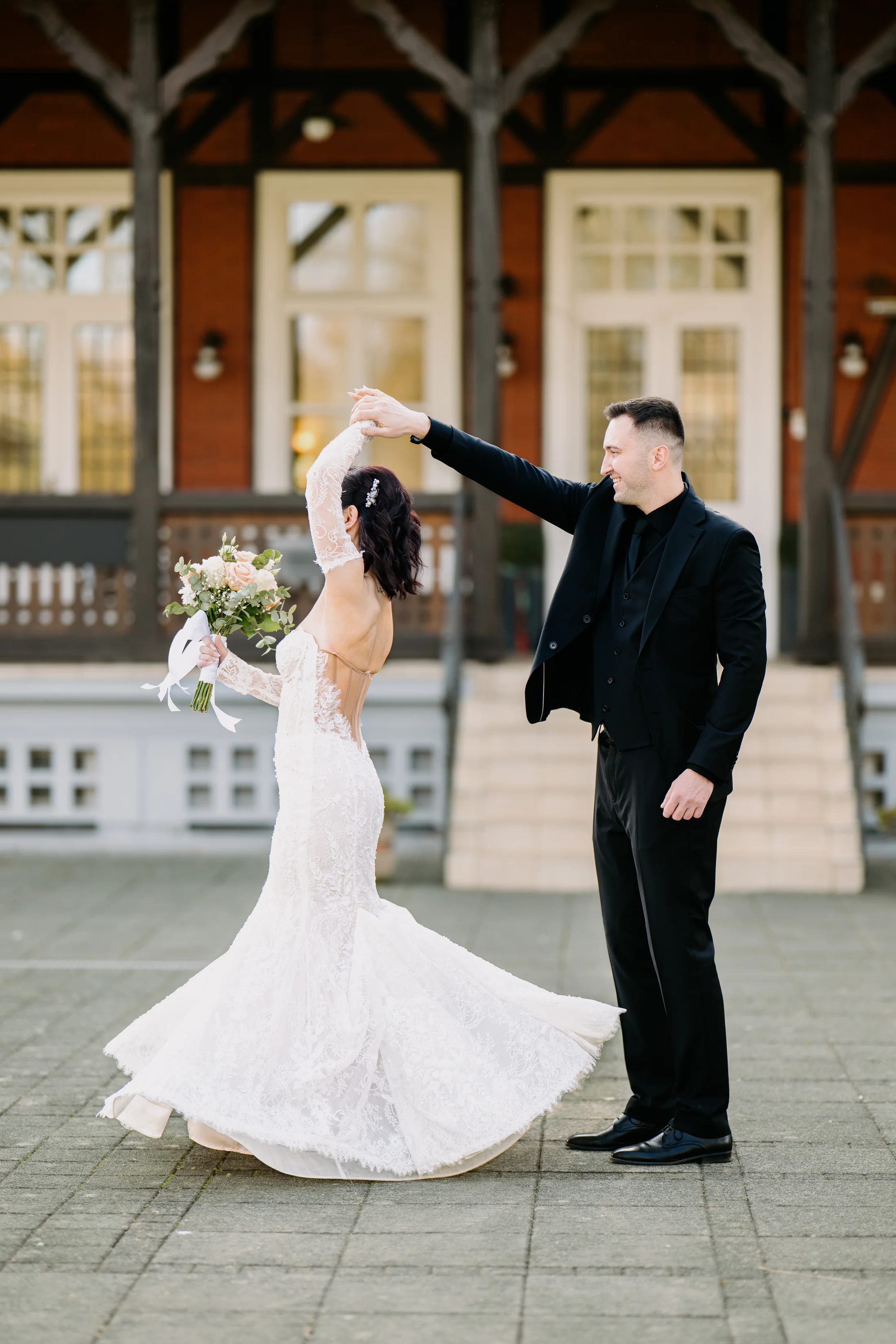 Bride twirling in front of historic architecture